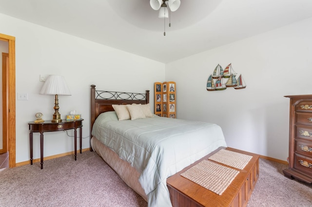 bedroom with light colored carpet, baseboards, and ceiling fan