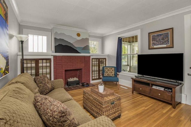 1449 Laurel Ave, Saint Paul, MN 55104 - living area with ornamental molding, a brick fireplace, wood finished floors, and healthy amount of natural light