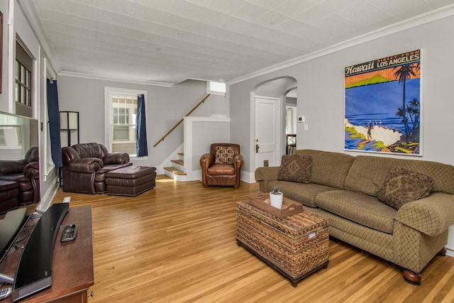 1449 Laurel Ave, Saint Paul, MN 55104 - living area featuring arched walkways, crown molding, light wood-style flooring, and stairway