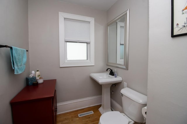1449 Laurel Ave, Saint Paul, MN 55104 - half bath featuring toilet, wood finished floors, and baseboards
