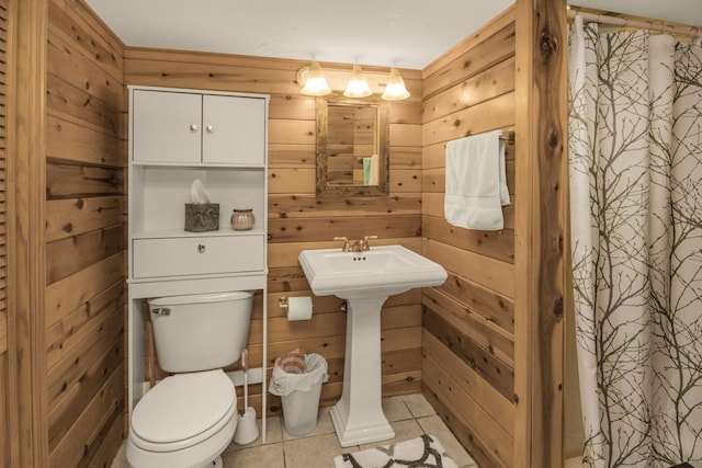 1449 Laurel Ave, Saint Paul, MN 55104 - bathroom with wooden walls, toilet, tile patterned flooring, and a shower with shower curtain