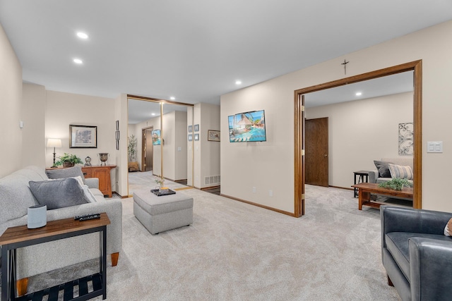 living room with visible vents, recessed lighting, baseboards, and light carpet