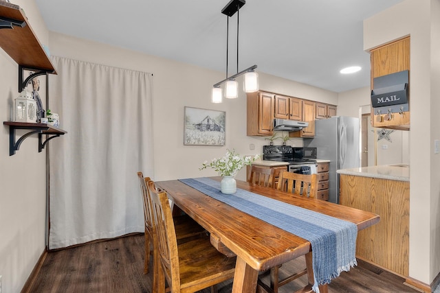 dining room featuring dark wood-style flooring, baseboards, and recessed lighting