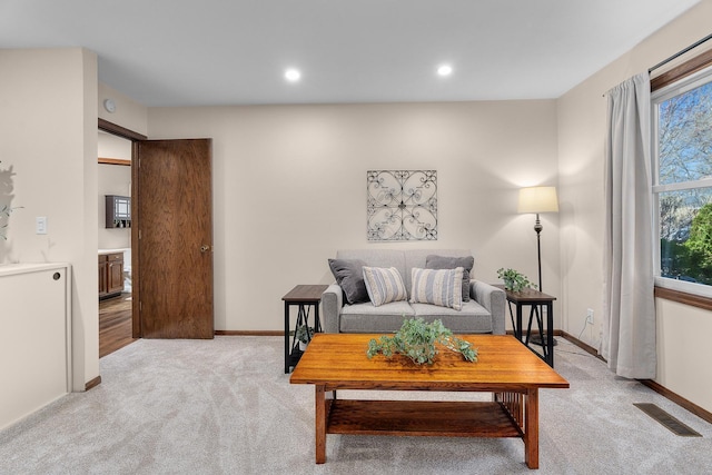 living room with visible vents, recessed lighting, baseboards, and light carpet