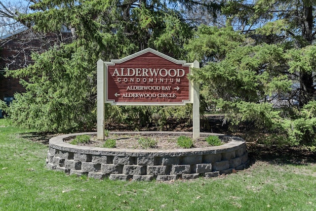 community / neighborhood sign with a yard