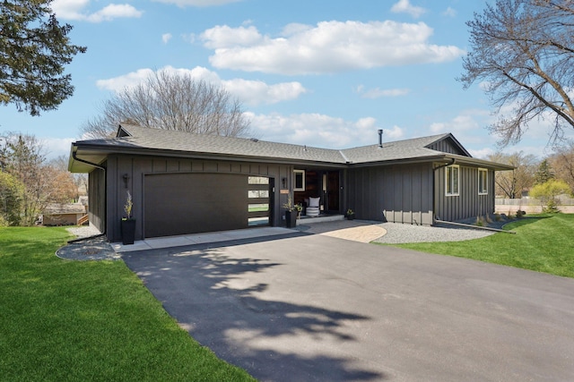 17725 26th Ave N, Plymouth, MN 55447 - view of front of home with board and batten siding, an attached garage, driveway, and a front lawn