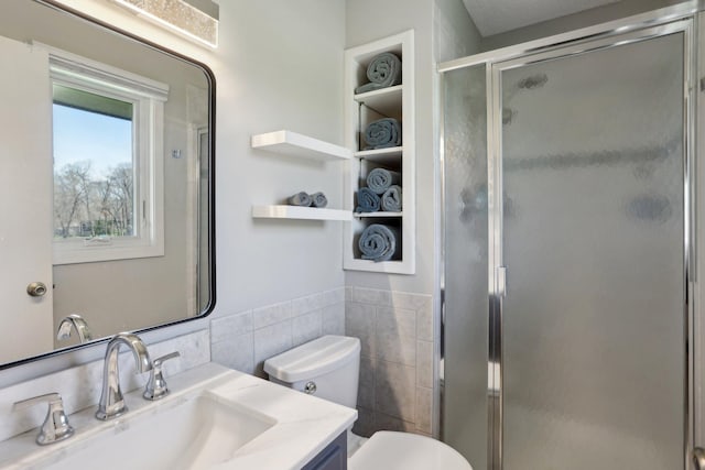 17725 26th Ave N, Plymouth, MN 55447 - full bathroom with vanity, wainscoting, toilet, tile walls, and a stall shower