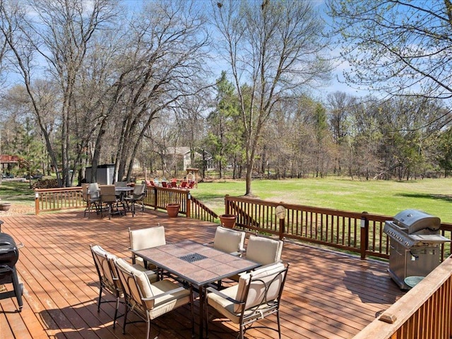 14898 Lynndale Ln, Baxter, MN 56425 - wooden deck with outdoor dining area, a lawn, and area for grilling