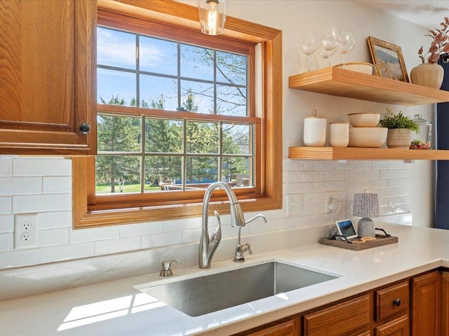 14898 Lynndale Ln, Baxter, MN 56425 - kitchen featuring open shelves, a sink, brown cabinetry, and decorative backsplash