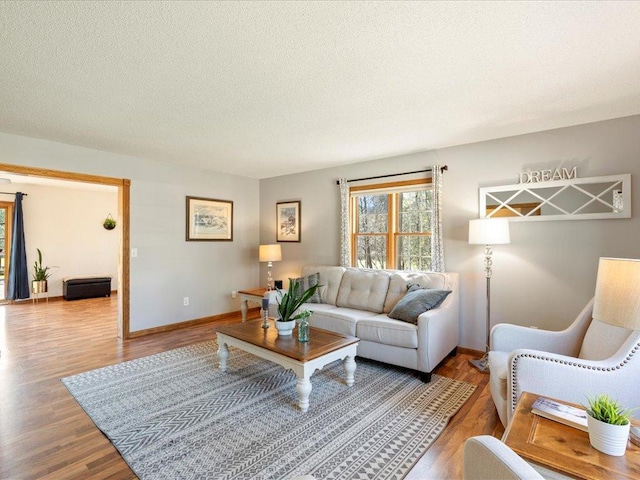 14898 Lynndale Ln, Baxter, MN 56425 - living area featuring wood finished floors, baseboards, and a textured ceiling
