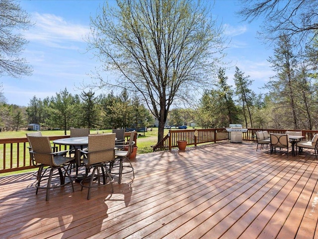 14898 Lynndale Ln, Baxter, MN 56425 - wooden deck with outdoor dining space and a yard