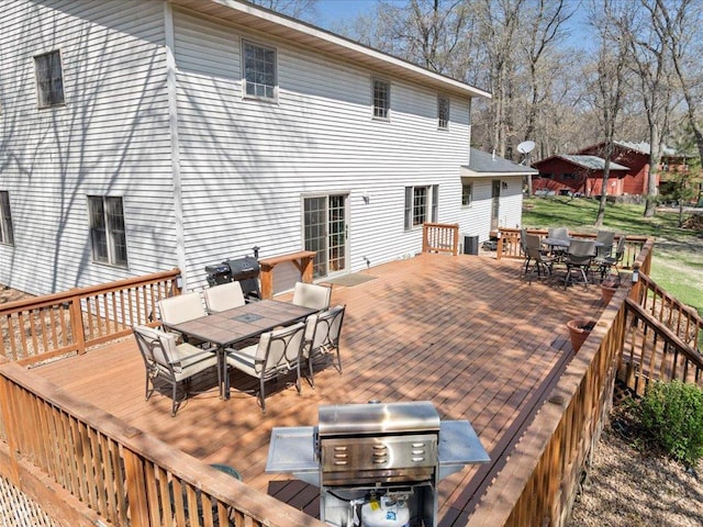 14898 Lynndale Ln, Baxter, MN 56425 - wooden terrace with outdoor dining area and a grill