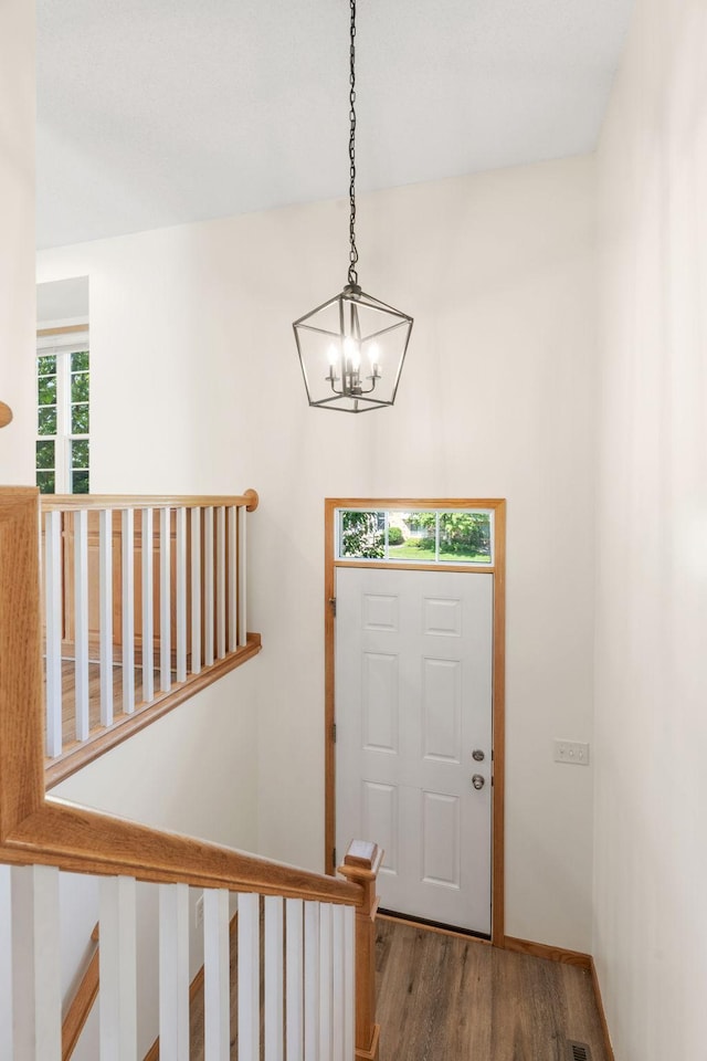 5030 Yuma Ln N, Plymouth, MN 55446 - entrance foyer featuring a chandelier, wood finished floors, and stairs