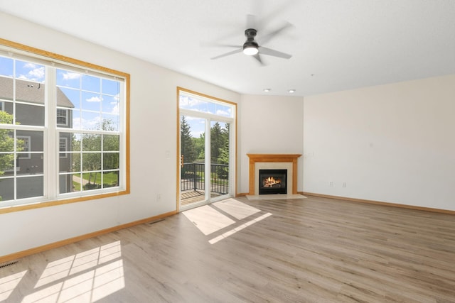 5030 Yuma Ln N, Plymouth, MN 55446 - unfurnished living room featuring light wood finished floors, ceiling fan, baseboards, and a fireplace with flush hearth