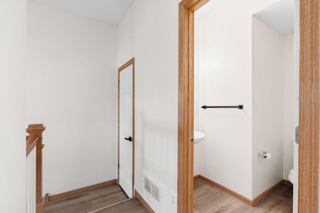5030 Yuma Ln N, Plymouth, MN 55446 - bathroom featuring wood finished floors, toilet, and baseboards
