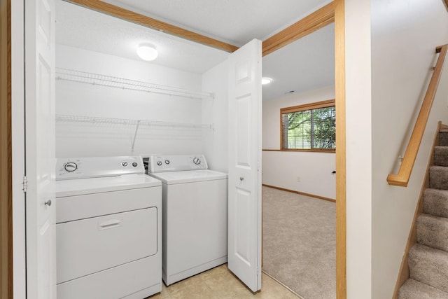 5030 Yuma Ln N, Plymouth, MN 55446 - laundry room featuring washing machine and dryer, baseboards, and light colored carpet