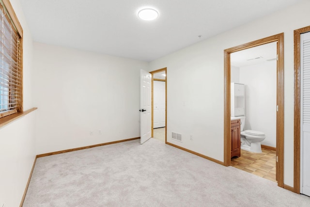 5030 Yuma Ln N, Plymouth, MN 55446 - unfurnished bedroom featuring light colored carpet, ensuite bathroom, and baseboards