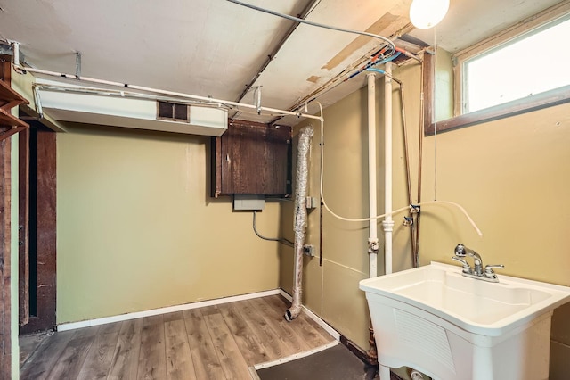interior space featuring visible vents, a sink, and wood finished floors