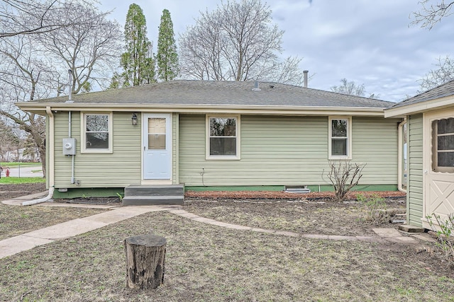 exterior space featuring a shingled roof
