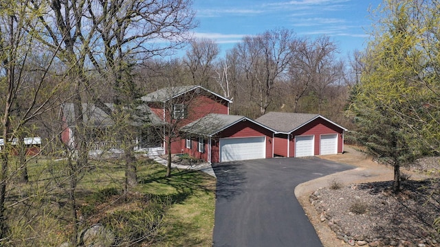view of front of home with a garage and aphalt driveway