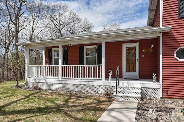 view of front of house with a porch, a front lawn, and roof with shingles