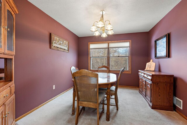 dining space with an inviting chandelier, baseboards, light carpet, and visible vents