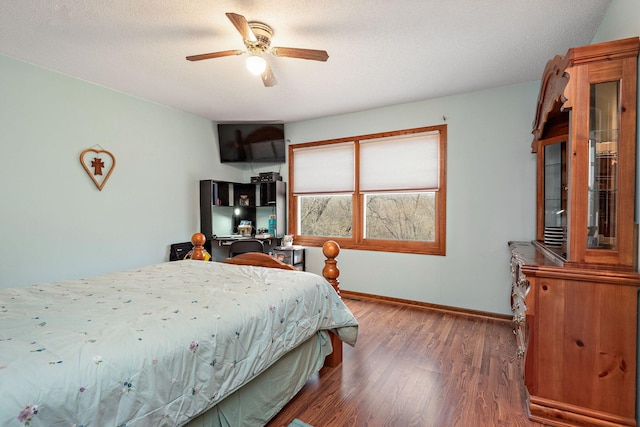 bedroom featuring baseboards, a ceiling fan, and wood finished floors