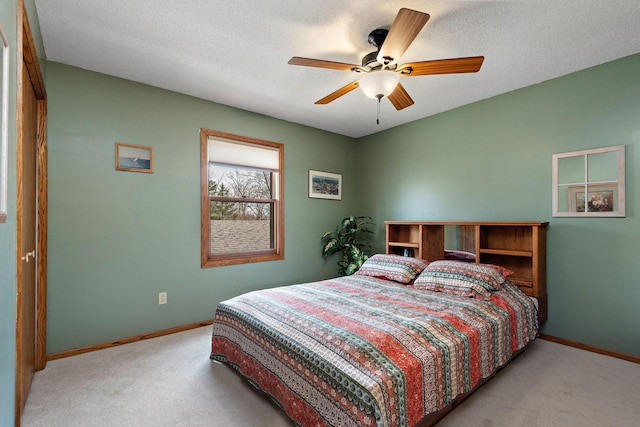 bedroom featuring baseboards, ceiling fan, and carpet flooring
