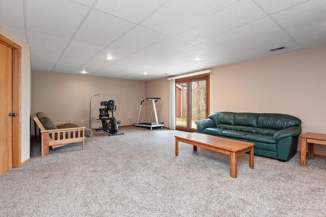 living area with carpet flooring, a drop ceiling, and visible vents