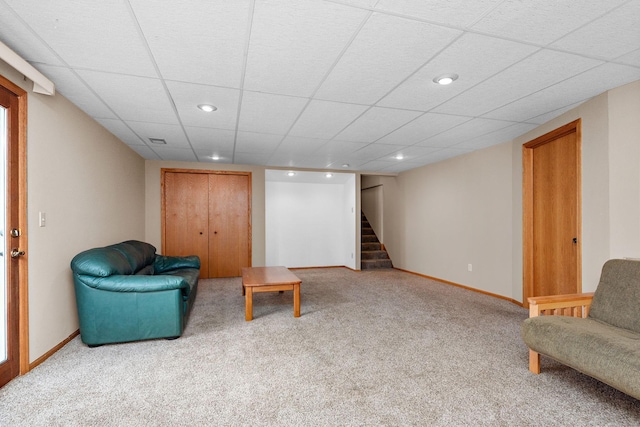 living area with carpet floors, baseboards, recessed lighting, and stairs