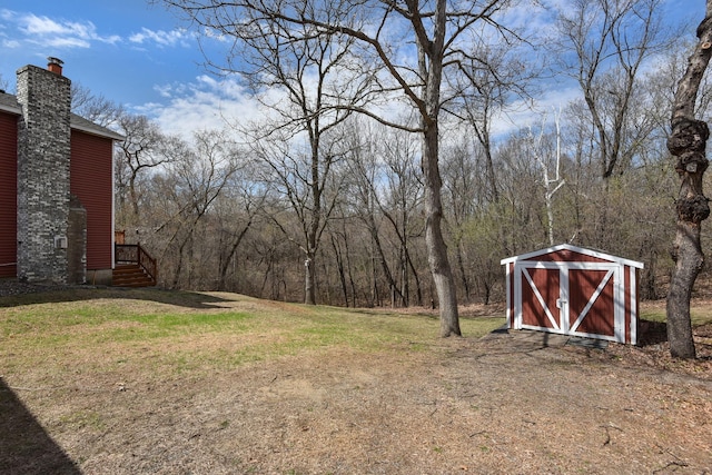 view of yard featuring a storage unit and an outbuilding