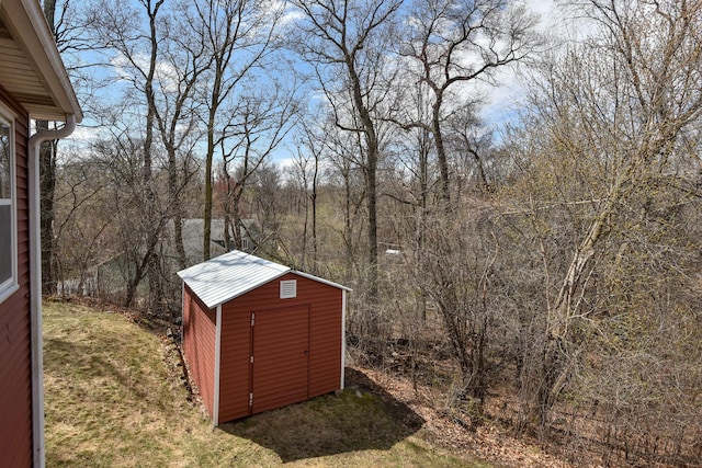 view of shed featuring a view of trees