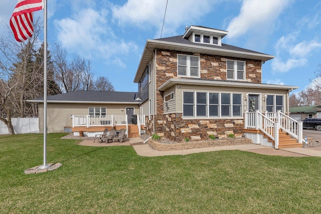 131 Norman Ave N, Foley, MN 56329 - rear view of property featuring a lawn, a patio, fence, and stone siding