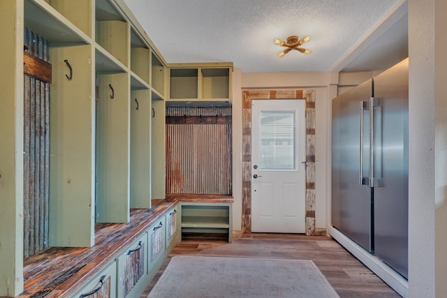 131 Norman Ave N, Foley, MN 56329 - mudroom featuring a textured ceiling and wood finished floors