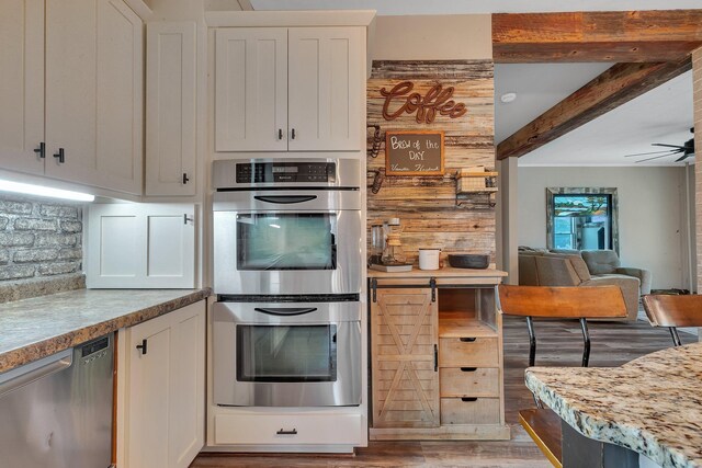 131 Norman Ave N, Foley, MN 56329 - kitchen featuring backsplash, beam ceiling, light wood finished floors, stainless steel appliances, and white cabinetry