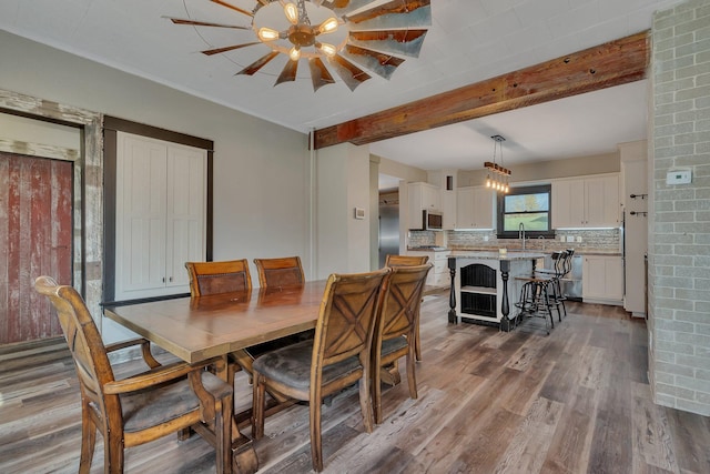 131 Norman Ave N, Foley, MN 56329 - dining space featuring beam ceiling and wood finished floors