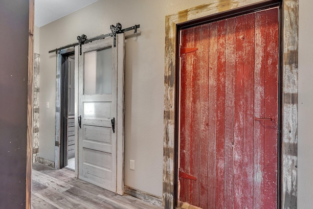 131 Norman Ave N, Foley, MN 56329 - room details featuring a barn door and wood finished floors