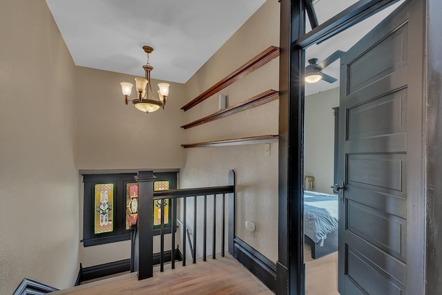 131 Norman Ave N, Foley, MN 56329 - stairs featuring baseboards, a notable chandelier, a textured wall, and wood finished floors