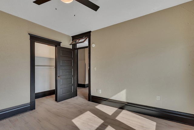 131 Norman Ave N, Foley, MN 56329 - unfurnished bedroom featuring a ceiling fan, baseboards, and light wood-style flooring