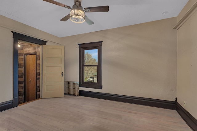 131 Norman Ave N, Foley, MN 56329 - empty room featuring wood finished floors, ceiling fan, and radiator heating unit