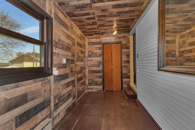 131 Norman Ave N, Foley, MN 56329 - hallway with wood walls, dark wood-style flooring, and wooden ceiling