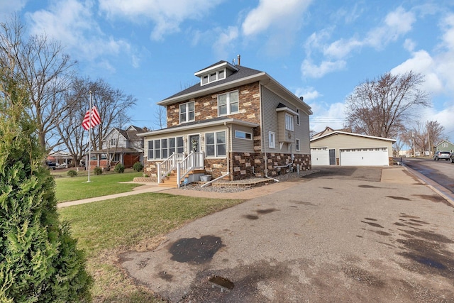 131 Norman Ave N, Foley, MN 56329 - rear view of house with a detached garage, an outdoor structure, a lawn, and stone siding