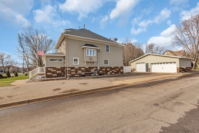 131 Norman Ave N, Foley, MN 56329 - view of front of house featuring a garage, an outdoor structure, and stone siding