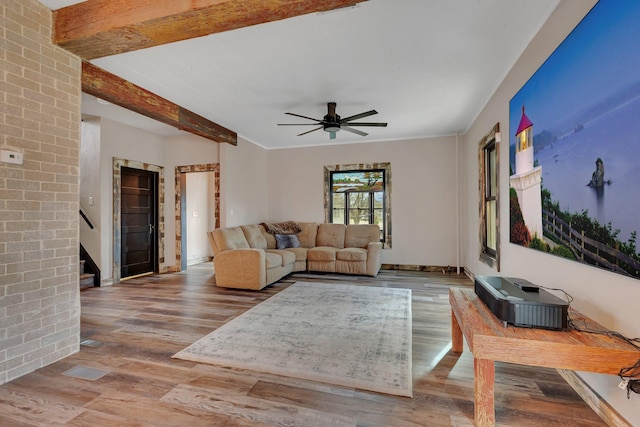 131 Norman Ave N, Foley, MN 56329 - living area featuring beam ceiling, stairs, a ceiling fan, wood finished floors, and visible vents