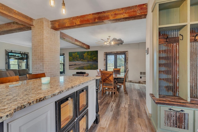 131 Norman Ave N, Foley, MN 56329 - kitchen with plenty of natural light, beamed ceiling, dark wood-style floors, and open floor plan