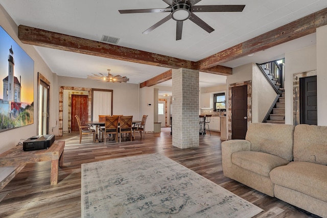131 Norman Ave N, Foley, MN 56329 - living area featuring ceiling fan, decorative columns, wood finished floors, beamed ceiling, and visible vents