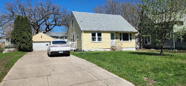 211 2nd St, Albert Lea, MN 56007 - bungalow-style home featuring a detached garage, a front lawn, an outbuilding, and a shingled roof