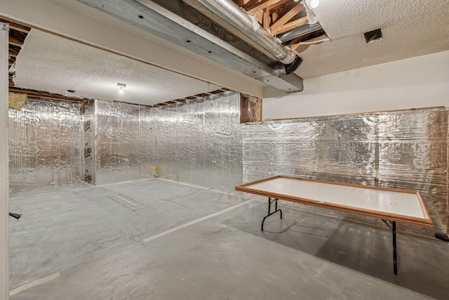 unfinished basement featuring a textured ceiling