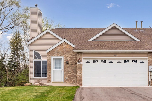 view of front of property featuring an attached garage, driveway, a shingled roof, and a chimney