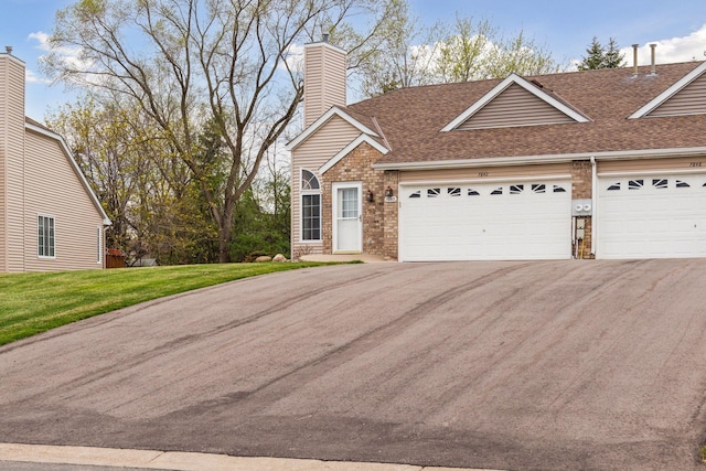 view of front of home featuring a garage, a shingled roof, driveway, and a chimney